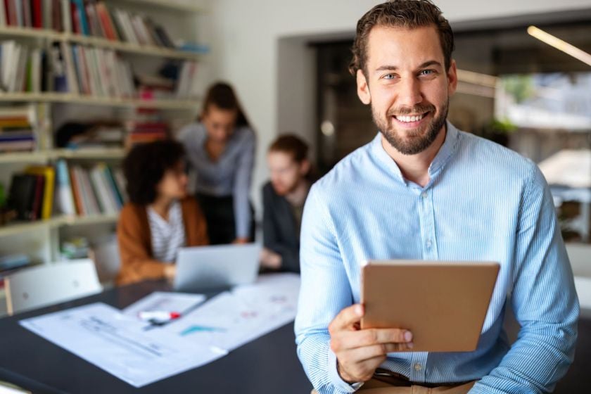 Man reading tablet in office
